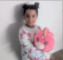 Young child holding pink plushie